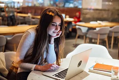 cute-girl-works-laptop-hipster-cafe